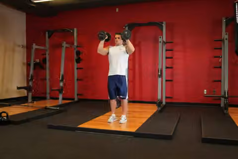 Demonstrasi gerakan Standing Palms-In Dumbbell Press.