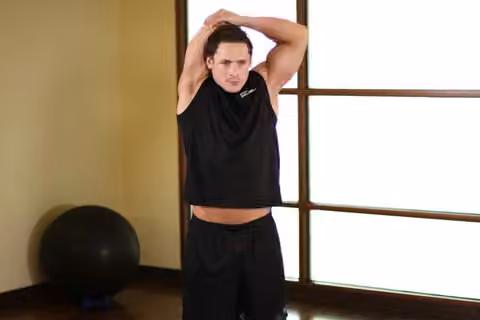 Demonstrasi gerakan Triceps Stretch.